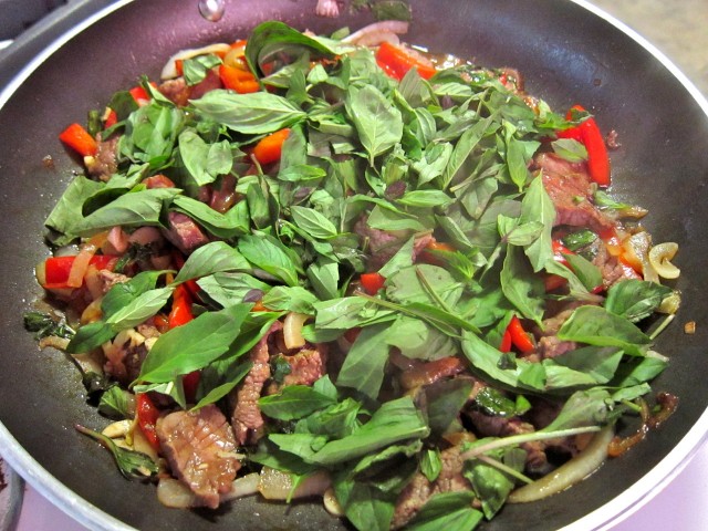 Thai basil beef adding basil