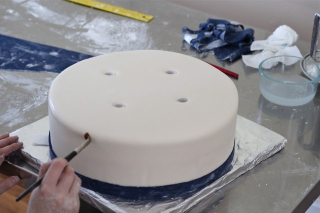 Wetting the fondant to apply stripes